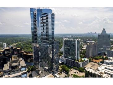 Stunning aerial view showcasing the modern high-rise building with city skyline and lush green landscape at 3344 Peachtree Ne Rd # 3601, Atlanta, GA 30326