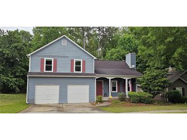 Charming two-story home with a two-car garage, red shutters, and mature trees in the front yard at 3236 Grove Nw Trl, Acworth, GA 30101