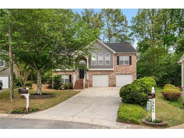 Charming two-story home with brick and gray siding, attached two-car garage, and well-manicured lawn with mature shade trees at 3607 Anna Nw Ln, Kennesaw, GA 30144