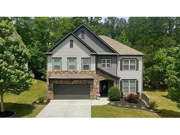 Charming two-story home with stone accents and meticulously manicured landscaping at 109 Red Fox Dr, Dallas, GA 30157