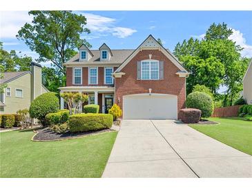 Charming two-story brick home with well-manicured lawn and inviting curb appeal at 450 Hammersmith Dr, Suwanee, GA 30024