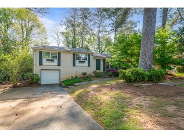 Charming single-story home with a well-maintained lawn and a one-car garage at 723 Monticello Se Way, Marietta, GA 30067