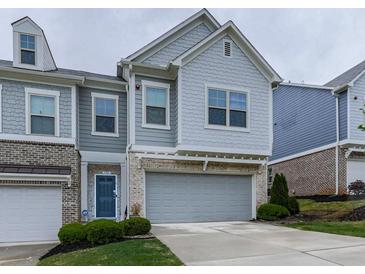 Charming two-story home with a brick and siding exterior, a two-car garage, and well-manicured landscaping at 130 Maple Creek Way, Woodstock, GA 30188