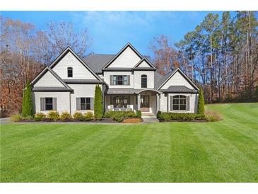 Beautiful two-story home with gray accents, lush lawn and elegant curb appeal in a wooded setting at 4370 Freys Farm Nw Ln, Kennesaw, GA 30152