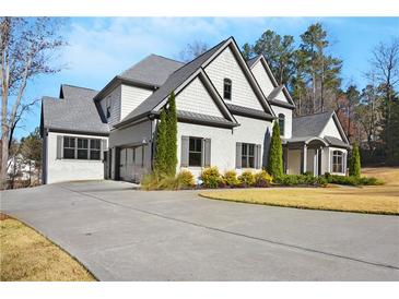 Charming two-story home featuring a long driveway and a three car garage, set on a well-manicured lawn at 4370 Freys Farm Nw Ln, Kennesaw, GA 30152