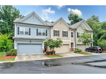 Charming townhome with multiple garages, landscaping, and neutral exterior paint colors at , Atlanta, GA 30316