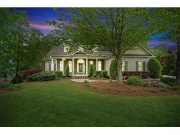 Charming single-Gathering home with well-manicured lawn, lush landscaping and inviting front porch at 5705 Twelve Oaks Dr, Cumming, GA 30028