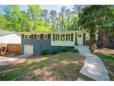 Charming home with a blue brick exterior, landscaped front yard, and inviting entrance at 1907 Shalimar Ne Dr, Atlanta, GA 30345