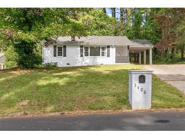 Charming single-story home with a white brick facade, inviting curb appeal, and well-maintained landscaping at 3406 Jackson Dr, Decatur, GA 30032