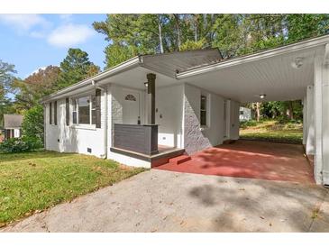 Charming single-story home featuring a convenient carport and covered front porch at 3406 Jackson Dr, Decatur, GA 30032