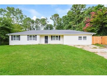 Charming single-story home boasts a well-manicured lawn, white exterior, and inviting curb appeal at 429 Landers Dr, Mableton, GA 30126