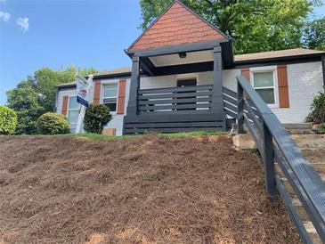 Charming home featuring a lovely covered porch and nicely landscaped yard with mature trees at 1298 Gideons Sw Dr, Atlanta, GA 30314