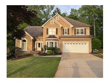 Charming two-story home with manicured lawn and two car garage at 989 Pinfeather Ct, Lawrenceville, GA 30043