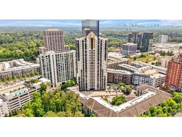 Stunning aerial view of a modern high-rise apartment complex surrounded by trees and city skyline at 3481 Lakeside Dr # 601, Atlanta, GA 30326