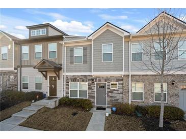Charming townhome with stone accents, neutral siding, manicured lawn and easy to navigate front steps at 813 Ambient Sw Way, Atlanta, GA 30331
