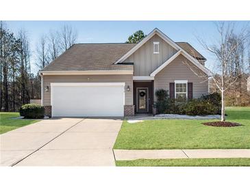 Charming single-story home featuring a two-car garage, well-maintained lawn, and neutral-toned siding at 4410 Chaney Ct, Cumming, GA 30028