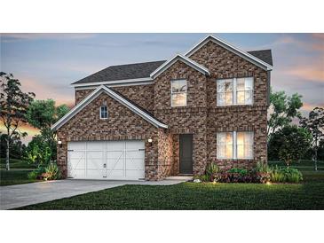 Charming two-story brick home with attached garage, manicured lawn, and inviting curb appeal at twilight at 129 Kenney Way, Locust Grove, GA 30248