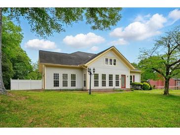 Charming single-story home with a well-manicured lawn and inviting curb appeal at 426 College E St, Bowdon, GA 30108