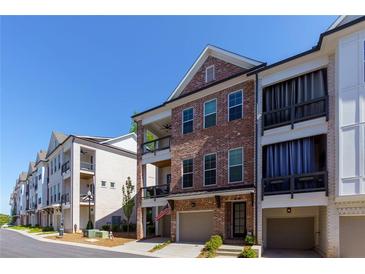 Beautiful brick townhome with two levels of balconies and attached two-car garage at 451 Burton Dr # 32, Alpharetta, GA 30009