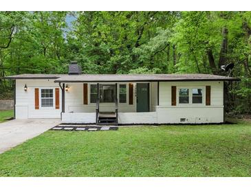 Charming renovated single-story home featuring updated landscaping, fresh exterior paint, and modern accents at 3458 Cooper St, Lithia Springs, GA 30122
