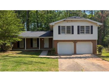 Charming two-story home with a well-maintained lawn and attached two-car garage at 1349 Cedar Heights Dr, Stone Mountain, GA 30083