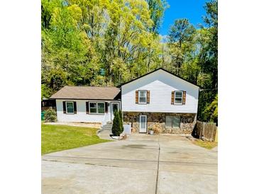 Charming two-story home with white siding, stone accents, and a well-manicured front yard at 1939 Suwanee Valley Rd, Lawrenceville, GA 30043