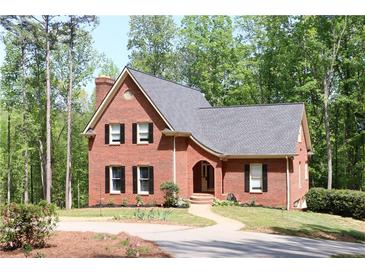 Charming brick home featuring a classic design, manicured landscaping, and a welcoming curved walkway at 349 Harris Loop, Dallas, GA 30157