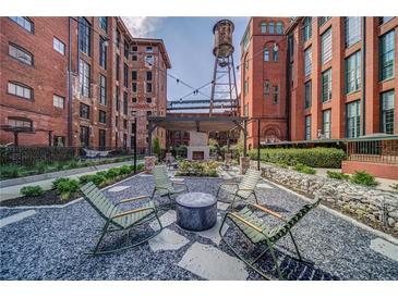 Beautiful outdoor courtyard featuring stylish seating and a cozy fireplace, great for entertaining at 170 Boulevard Se # E414, Atlanta, GA 30312