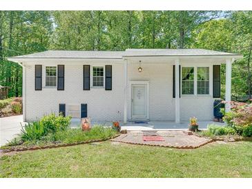 Charming white brick home with black shutters and well-maintained front yard landscaping at 3990 Admiral Dr, Chamblee, GA 30341