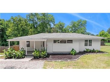 Charming single-story home with white siding, lovely landscaping, and a cozy front porch at 3132 Lunsford Cir, Covington, GA 30014