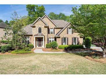 Beautiful two-story brick home with a stone facade and manicured landscaping at 1459 Hickory Branch Nw Trl, Kennesaw, GA 30152