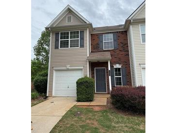Charming two-story home featuring brick accents, neutral siding, and a convenient one-car garage at 290 Azalea Cir, Cumming, GA 30040