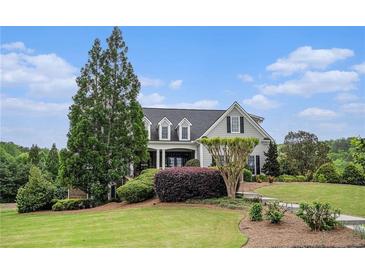 Charming home featuring a well-manicured lawn and lush landscaping at 639 Puckett Se Rd, Emerson, GA 30137