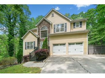 Charming two-story home with stone accents, a two-car garage, and well-maintained landscaping at 160 Wentworth Dr, Canton, GA 30114