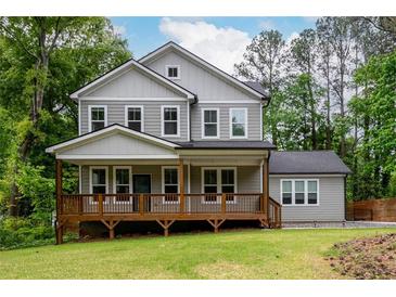 Charming two-story home with a inviting front porch nestled in a wooded lot at 2805 Pineland Ave, Atlanta, GA 30340