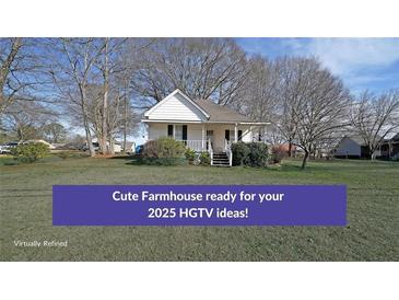 Charming single-story farmhouse featuring a cozy front porch and beautiful, established landscaping at 2651 Old Lost Mountain Rd, Powder Springs, GA 30127