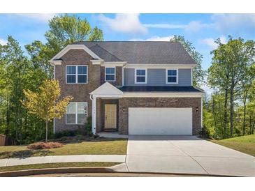 Charming two-story home with brick and stone accents, a well-manicured lawn and attached two-car garage at 312 Wichita Way, Mcdonough, GA 30253