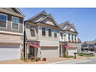 Charming new construction townhomes with brick and siding exterior details at 690 Stickley Oak Way, Woodstock, GA 30189