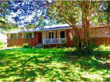 Charming brick home with a well-maintained front yard and a welcoming front porch at 5542 Joeclay Dr, Stone Mountain, GA 30088