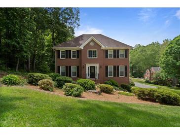 Traditional two-story brick home with mature landscaping and a well-manicured lawn at 4423 Windsor Oaks Cir, Marietta, GA 30066