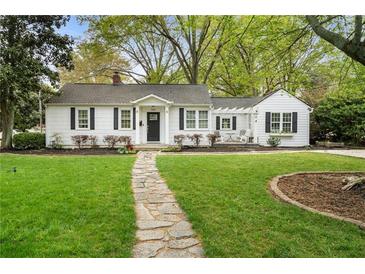 Charming home featuring a stone walkway, green lawn, and a quaint front exterior at 502 Allgood Ne Rd, Marietta, GA 30060
