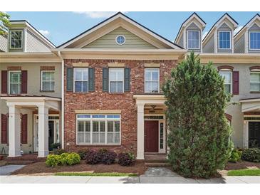 Charming brick townhouse with a well-maintained front yard and inviting entrance at 10686 Austen Bnd, Alpharetta, GA 30022