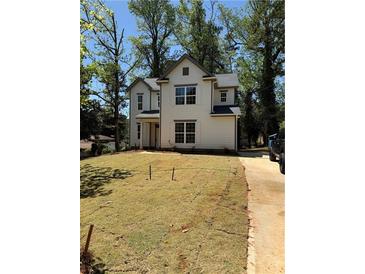 New construction features a charming two-story home with a well-manicured front yard and a classic architectural design at 3089 Corbin Ave, Decatur, GA 30034