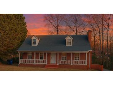 Charming brick home with dormer windows and a cozy front porch, perfect for enjoying scenic sunsets at 6841 Fairway Ridge Dr, Douglasville, GA 30134