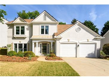 Charming two-story home with stucco exterior, well-manicured lawn, and a two-car garage at 3545 River Summit Trl, Duluth, GA 30097