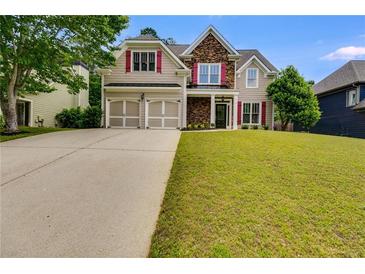 Charming two-story home featuring a two-car garage, stone accents, red shutters, and a well-manicured lawn at 36 Evergreen Way, Dallas, GA 30157