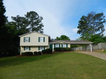Charming two-story home featuring a spacious front lawn, and a convenient carport at 820 Emerald Forest Cir, Lawrenceville, GA 30044