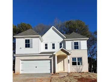 Beautiful two-story home showcasing a brick facade, modern white trim, and a two-car garage at 1715 Fulmont Cir, Mableton, GA 30126