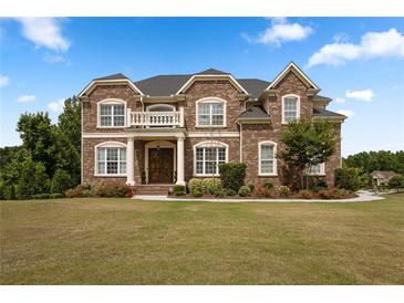 Elegant brick home features a covered porch, balcony, and lush landscaping at 365 Freeman Sw Ter, Atlanta, GA 30331