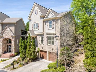 Charming two-story home featuring a two-car garage, complemented by lush landscaping and a well-maintained lawn at 1954 Saxon Valley Ne Cir, Brookhaven, GA 30319